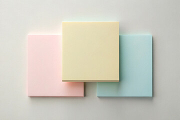 Trio of Pastel Notes: A neat arrangement of three pastel-colored square sticky notes, each radiating its unique hue.
