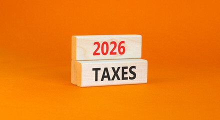 2026 taxes new year symbol. Concept words 2026 taxes on beautiful wooden blocks. Beautiful orange paper background. Business and 2026 taxes new year concept. Copy space.