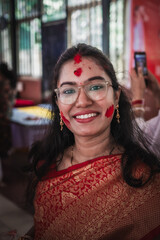 Beautiful Indian woman in traditional saree during Sindoor Khela, it is a bengali ritual where married women apply vermilion (sindoor) to each other on Vijayadashami, the last day of Durga Puja.