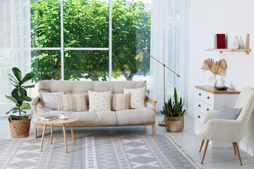 Beautiful living room with lamp, stylish furniture and plants. Interior design
