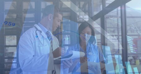 Doctor and nurse in uniforms reviewing charts in healthcare lobby, with stethoscopes printed charts