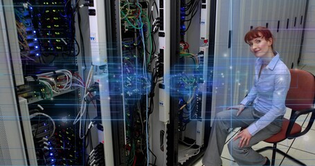 Technician in blue work clothes monitoring traffic in data center, with digital overlay, copy space