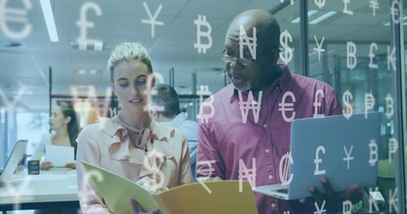 Reviewing financials burgundy-clad man with colleague in office, with laptop and currency symbols
