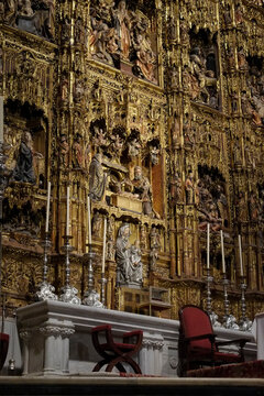 Seville, Spain. Gilded wall completer with numerous individual ornate religious carvings all completed by one artist. 