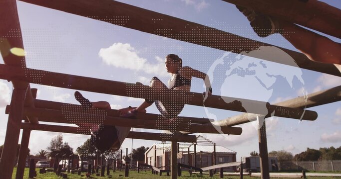 Balancing three athletes in sportswear traversing wooden beams on training field near metal frame