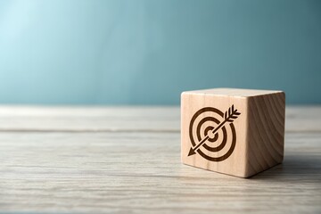 Wooden cube with target and arrow symbol representing business goals and success