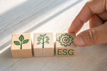 Hand places esg cube with gear icon next to plant growth cubes