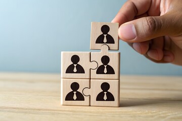 Hand placing final puzzle piece with person icon into team structure