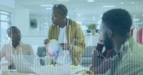 Showing man in mustard jacket sharing colors at office, with color wheel, swatches, clothing rack