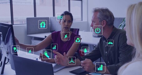 Pointing woman in sleeveless violet blouse indicating data on monitor in office, with eco icons