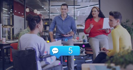 Discussing group of professionals collaborating around table in open office, with wheelchair