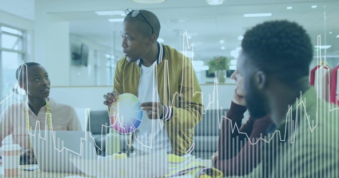 Showing man in mustard jacket sharing colors at office, with color wheel, swatches, clothing rack