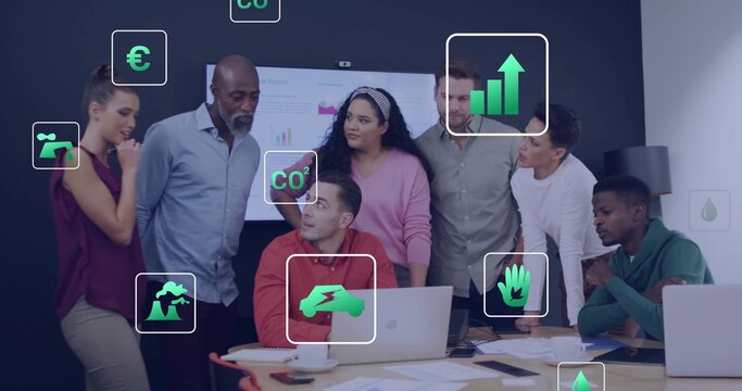 Collaborating business casual team analyzing charts in meeting room, with laptops and CO? icons