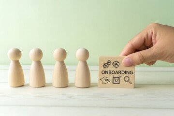 Hand placing onboarding cube with icons next to wooden peg people