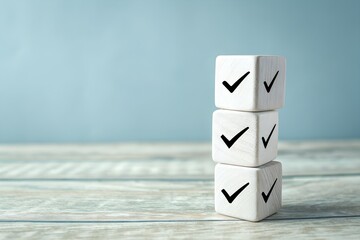 Stack of white cubes with checkmarks on a wooden surface