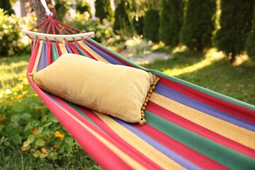 Comfortable cushion on colorful hammock in garden, closeup