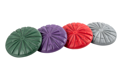 Four colorful, textured, round objects arranged diagonally on a black backdrop