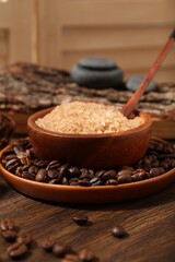 Natural sea salt and coffee beans on wooden table, closeup