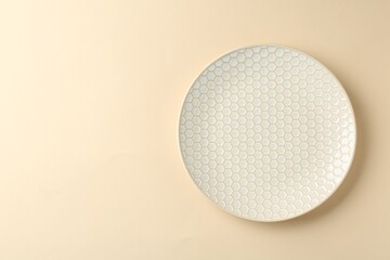 Stylish ceramic plate on beige background, top view. Space for text