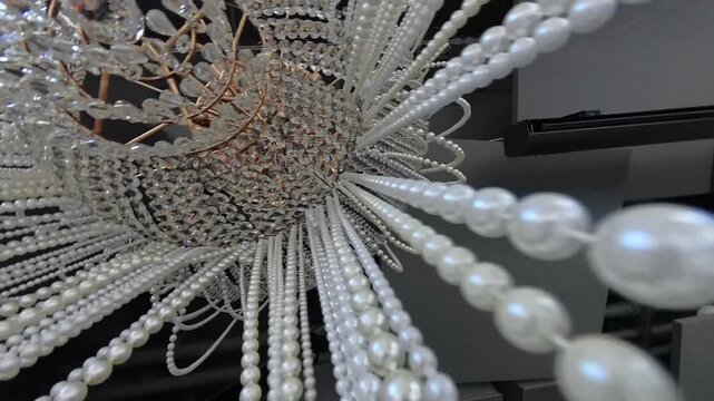 Pearl on the chandelier with long dangling threads