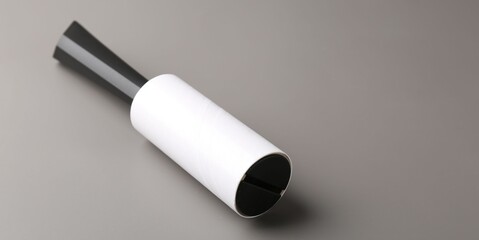 One lint roller on grey background, closeup. Space for text