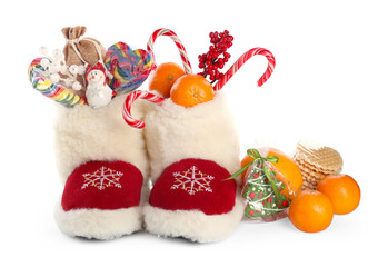 Saint Nicholas day. Boots with treats and festive decor isolated on white
