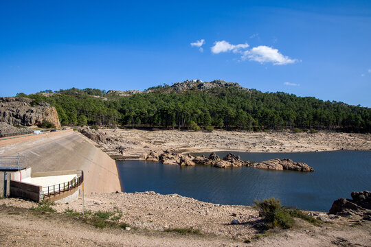 the Ospedale reservoir with dam and low water level, dry shore in sunshine