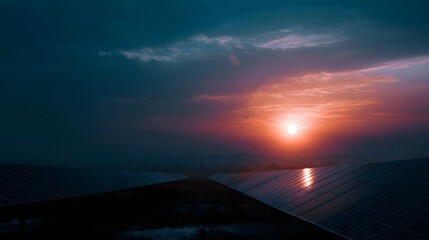 Vibrant sunset over a vast solar panel field casting a warm glow