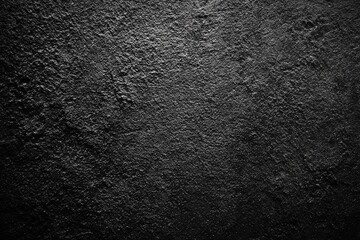 A highly textured, dark, and rough surface with an uneven appearance dominates the frame