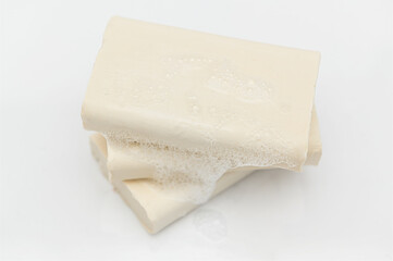 White natural handmade soap with foam on white background.