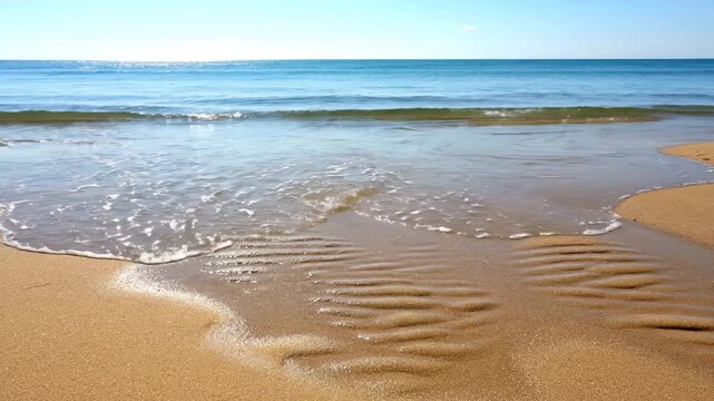 Peaceful ocean tide ebbing and flowing on a sandy beach, revealing wet patterns over time pristine, coastal, waterfront