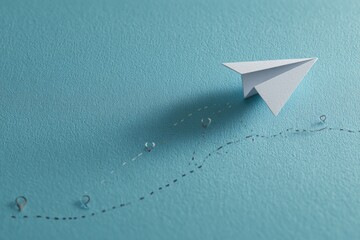 A paper airplane, on a light blue wall with dotted path and marker pins, suggesting a journey