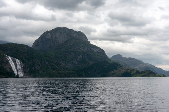 Laukelandshesten, elevation 678&nbsp;meter, Laukelandsfossen waterfall, Dalsfjorden - fjord in Vestland county, gloomy sky, Norway.