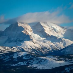 Majestic snow-capped mountains under a cloudy blue sky