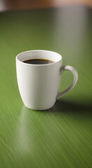 A white mug filled with dark coffee sits on a textured green surface.