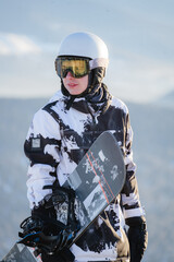 Portrait of a happy teenage boy on a mountain top wearing a helmet and yellow glasses