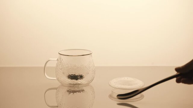 Minimal tea brewing ritual in glass cup, calm aesthetic video.  Pouring hot water in glass cap with black tea. 4K  video.