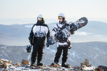 two men at the top of a ski resort