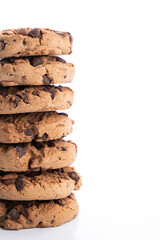 vertical stack of chocolate chip cookies piled on a white background