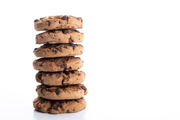 pile of chocolate chip cookies stacked on a white background