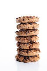 vertical stack of chocolate chip cookies piled on a white background