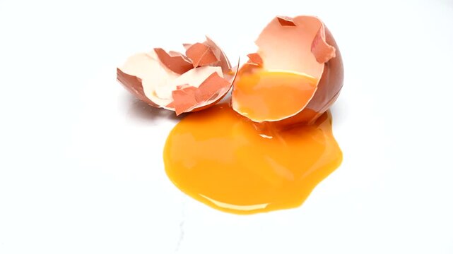 single broken egg with yolk