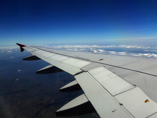 Fototapeta premium Airplane window view, Airplane flying in the sky, Airplane wing&nbsp;,Airplane wing, In-flight sky view