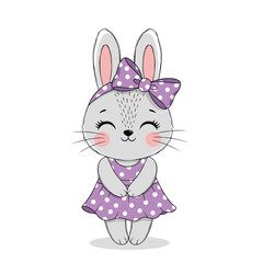 A cute little bunny wearing a purple polka dot dress and a matching bow.
