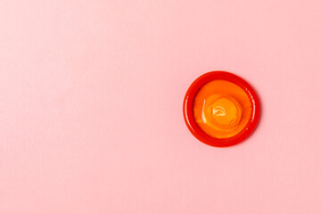 Condoms on a colored background. Colorful fruit-themed condoms in packaging. Safe sex concept....