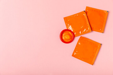 Condoms on a colored background. Colorful fruit-themed condoms in packaging. Safe sex concept. Contraceptive. Different birth control methods. Aids prevention. World AIDS Day. Sexual health.