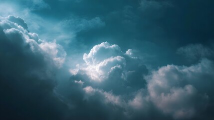 Obraz premium Dramatic dark blue sky filled with illuminated and shadowed clouds creating an atmospheric scene