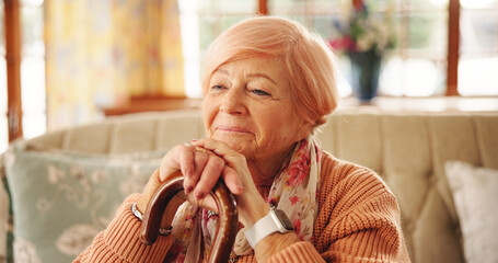 Cane, thinking and senior woman in home with hope, nostalgia and memory with vision. Walking stick, reflection and elderly person with disability, happiness and remember in retirement in living room
