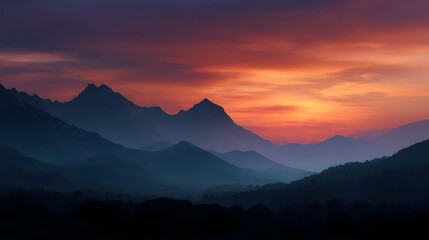 Naklejka premium Layered mountain silhouette at vibrant sunset painted with orange red and purple hues