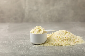 Protein powder. A spoonful of protein powder on a table. Different flavors of whey protein powder. Sports nutrition concept. Gym. Amino acid food supplement, creatine powder. Copy space.